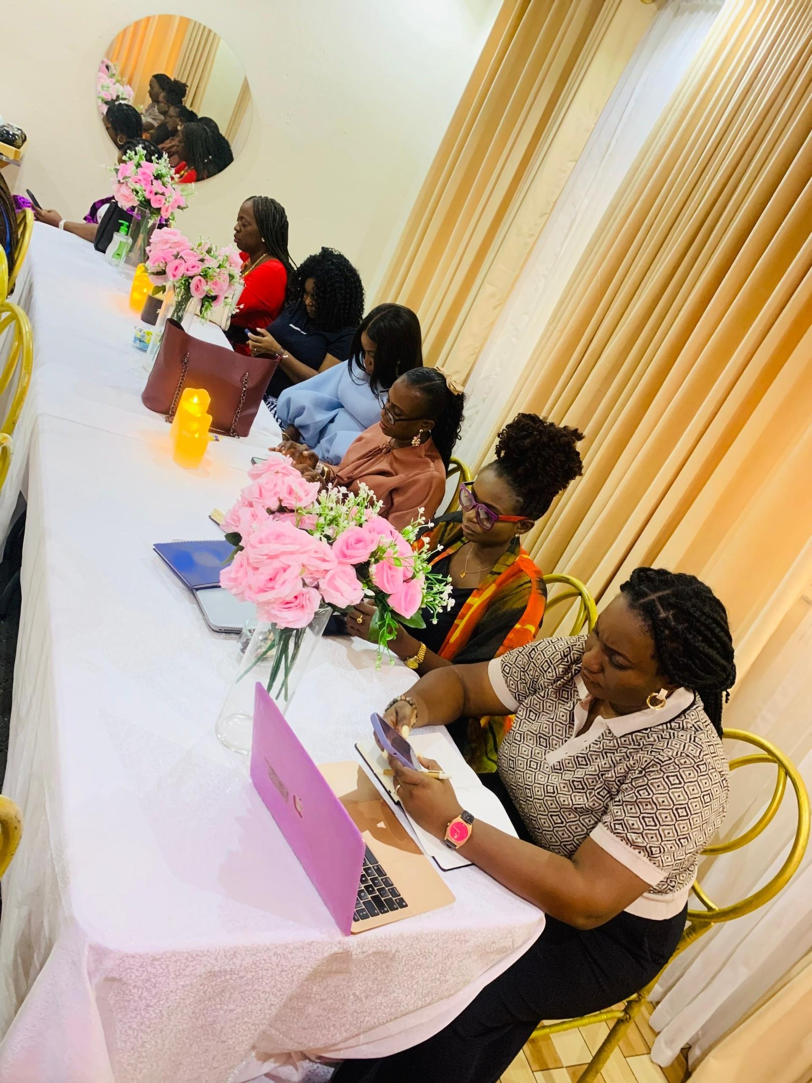 Women seated around a long table at a DPW Tea Party