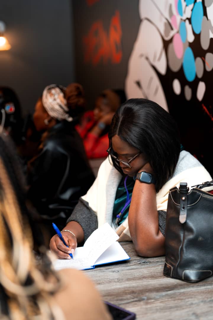 An attendee writing during a session at the DPW Europe Retreat 2026