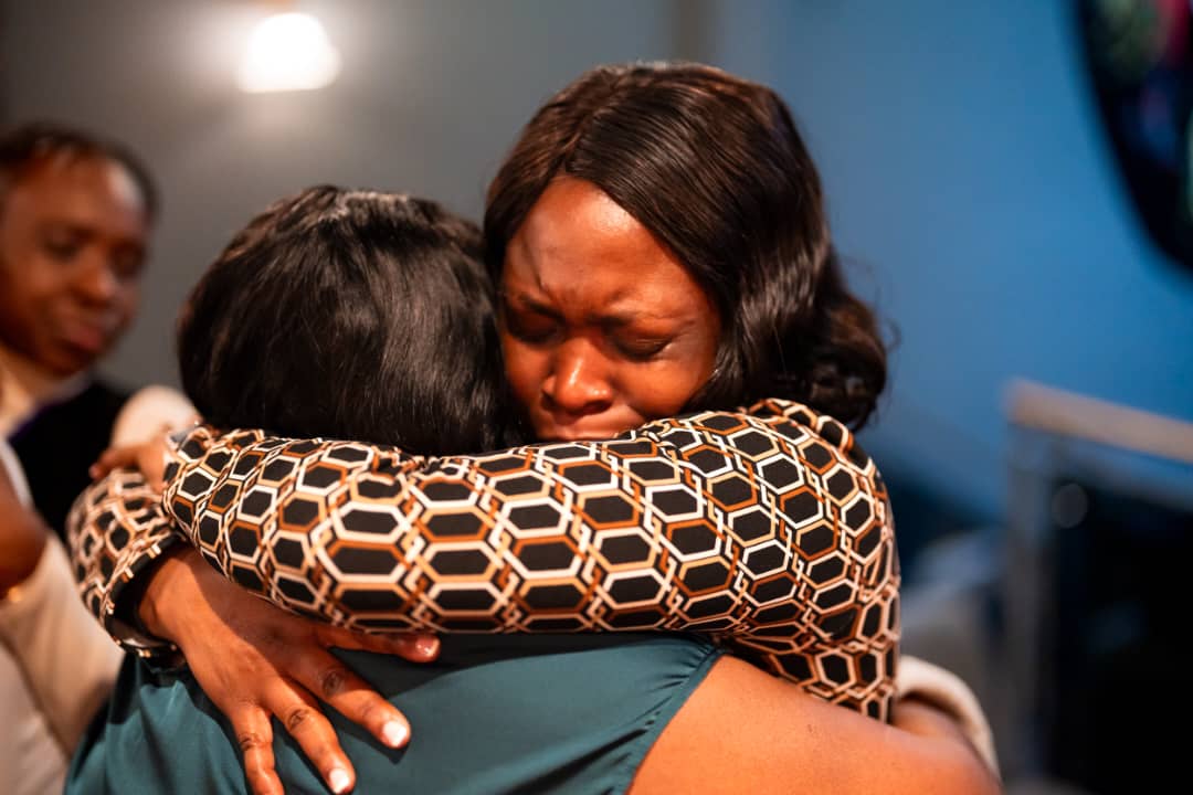 A warm embrace between attendees at the DPW Europe Retreat 2026