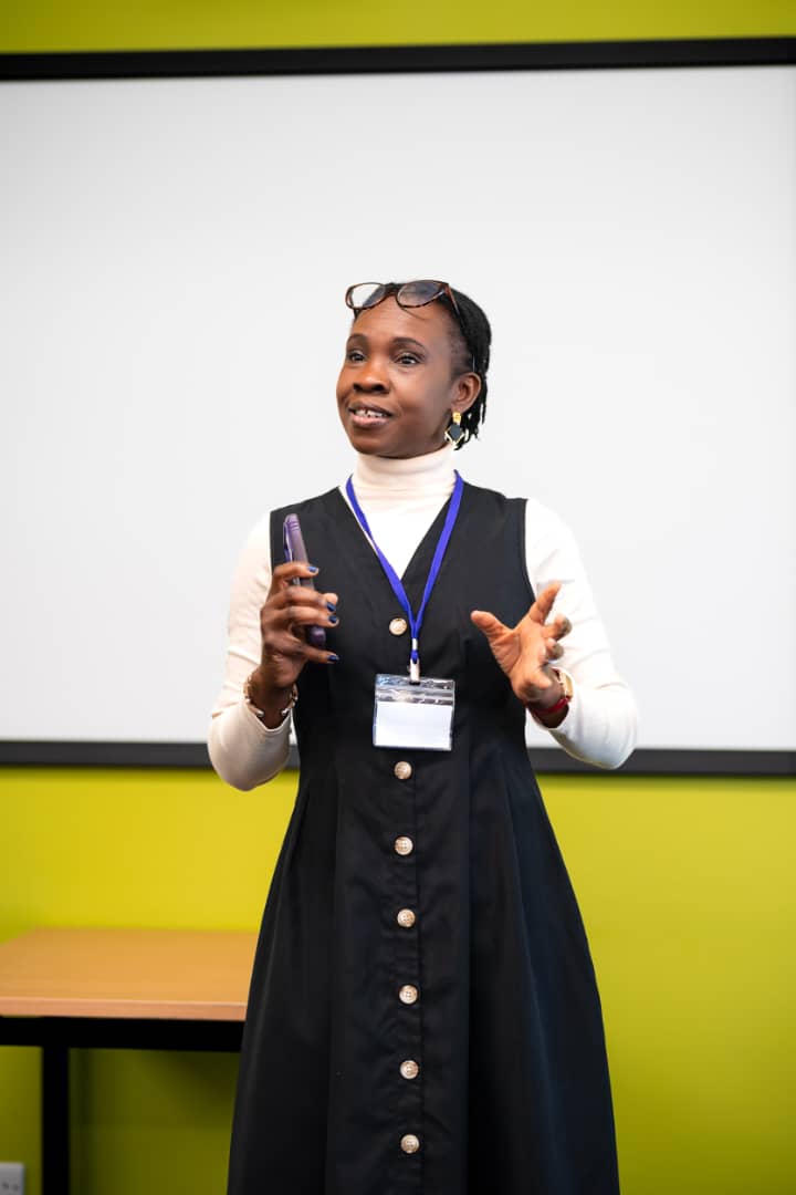 A speaker holding a microphone at the DPW Europe Retreat 2026