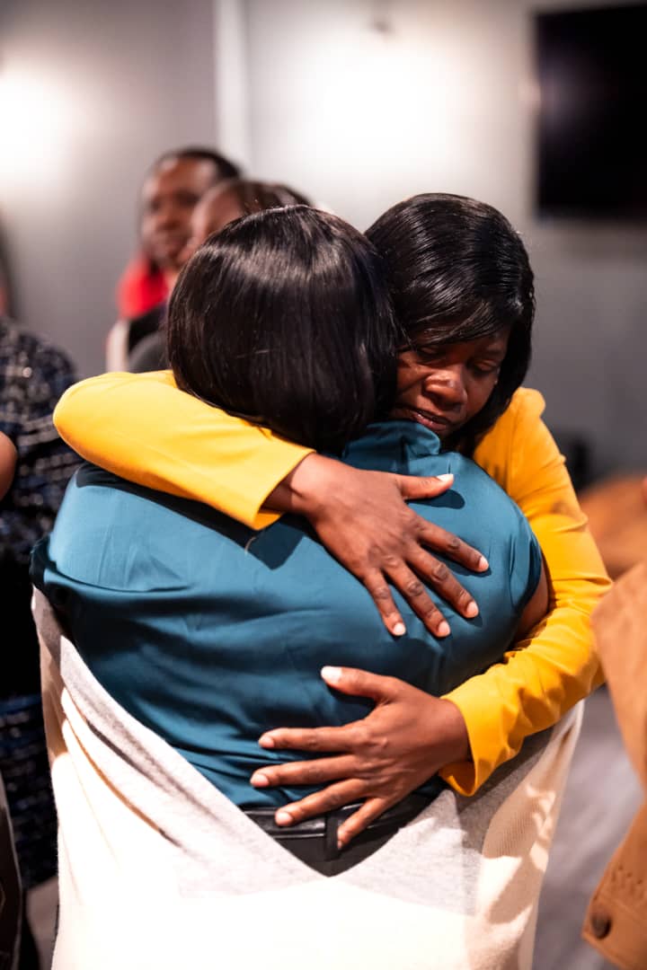 Attendees embracing at the DPW Europe Retreat 2026