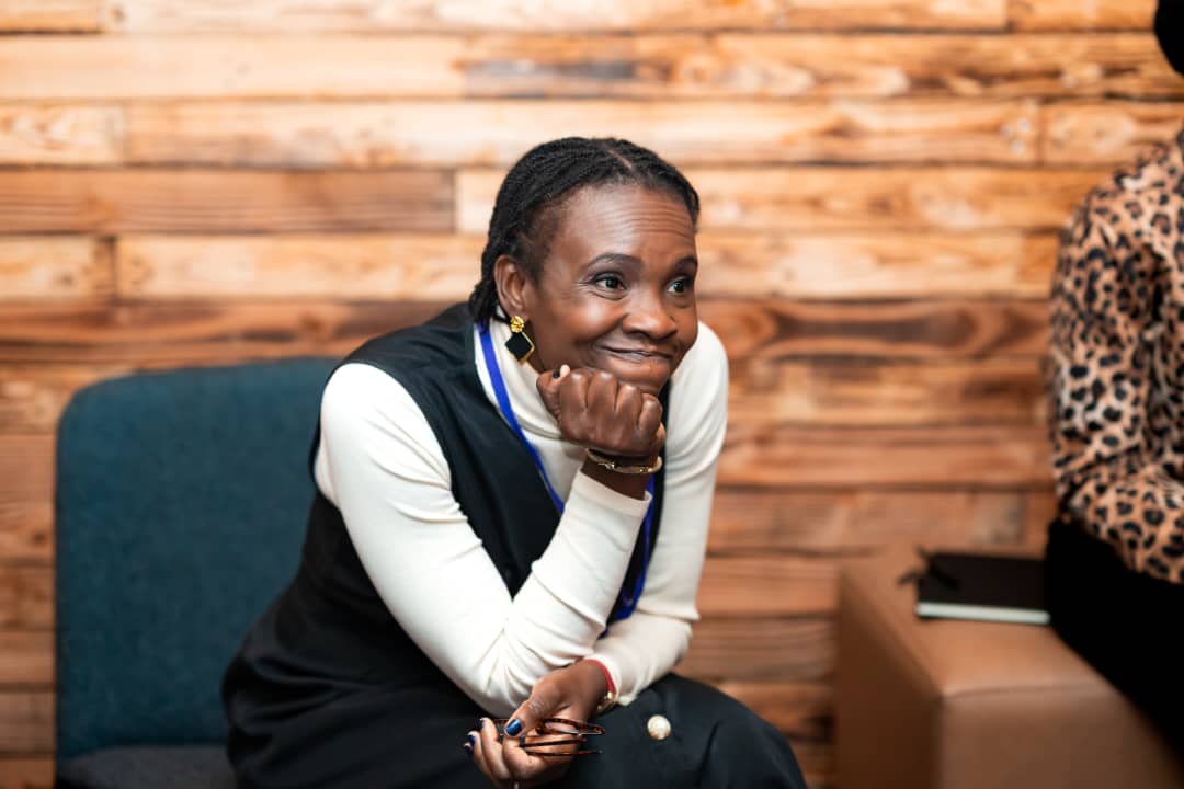 A smiling attendee during a session at the DPW Europe Retreat 2026